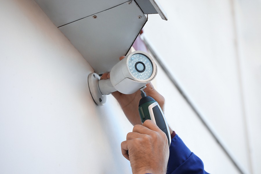 Technician Installing Cctv Camera On Wall Outdoors, Closeup